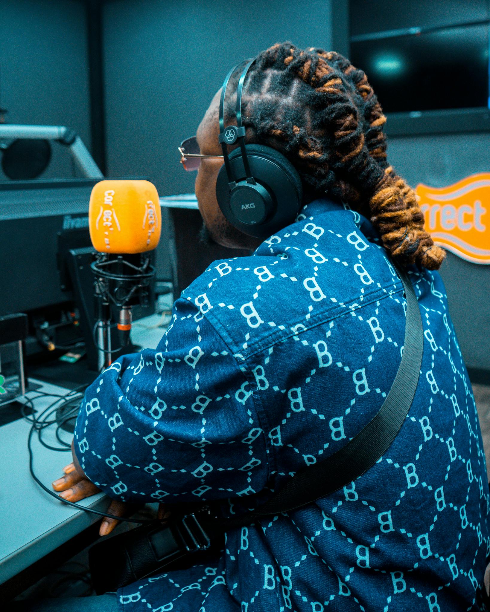 Podcaster in Studio with Orange Microphone